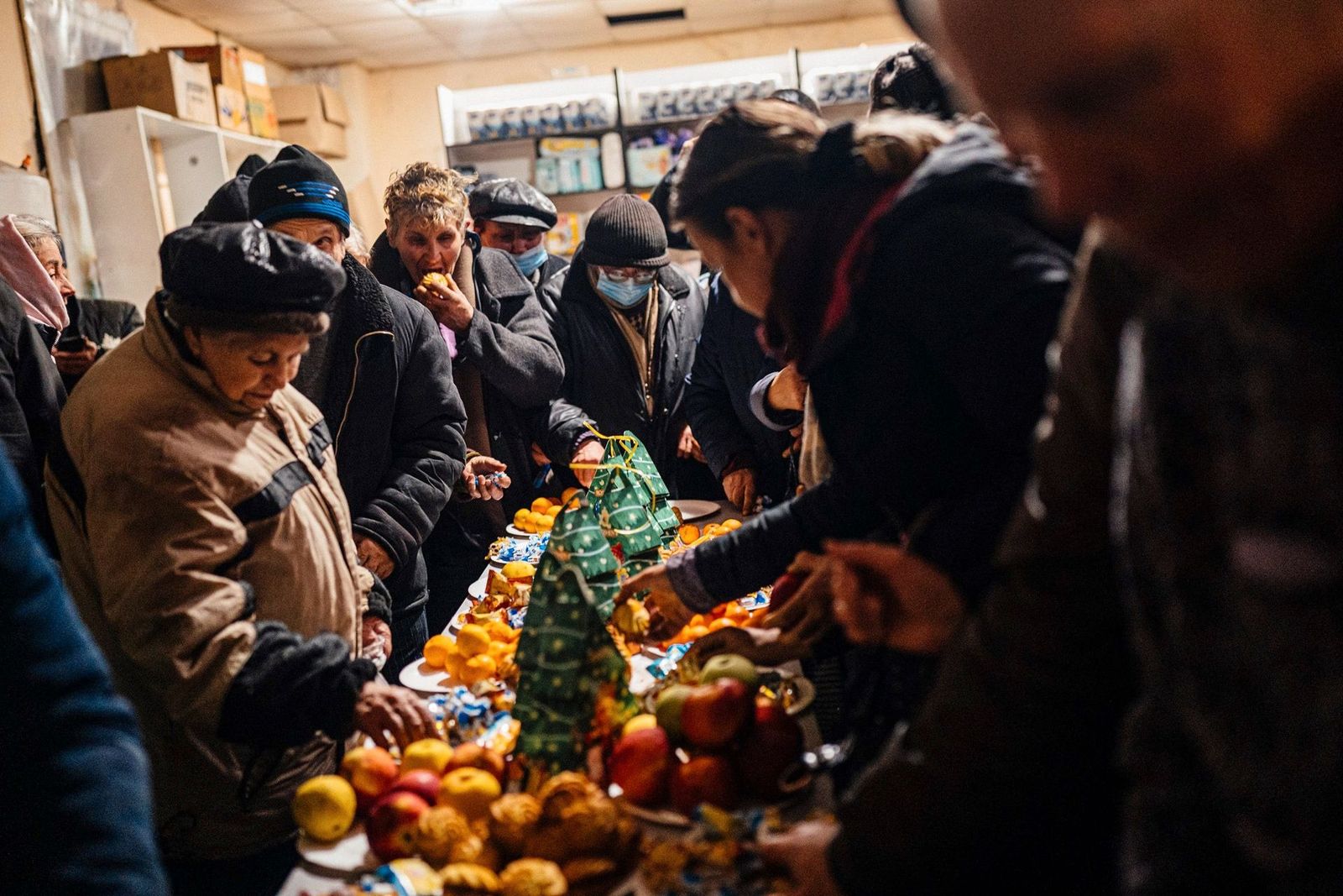 Жители Бахмута угощаются продуктами в центре гуманитарной помощи. Непрерывные бои за город продолжаются с августа, примерно всё это время у жителей нет воды, тепла и электричества. Тем не менее там еще остались люди, которые отказываются эвакуировать