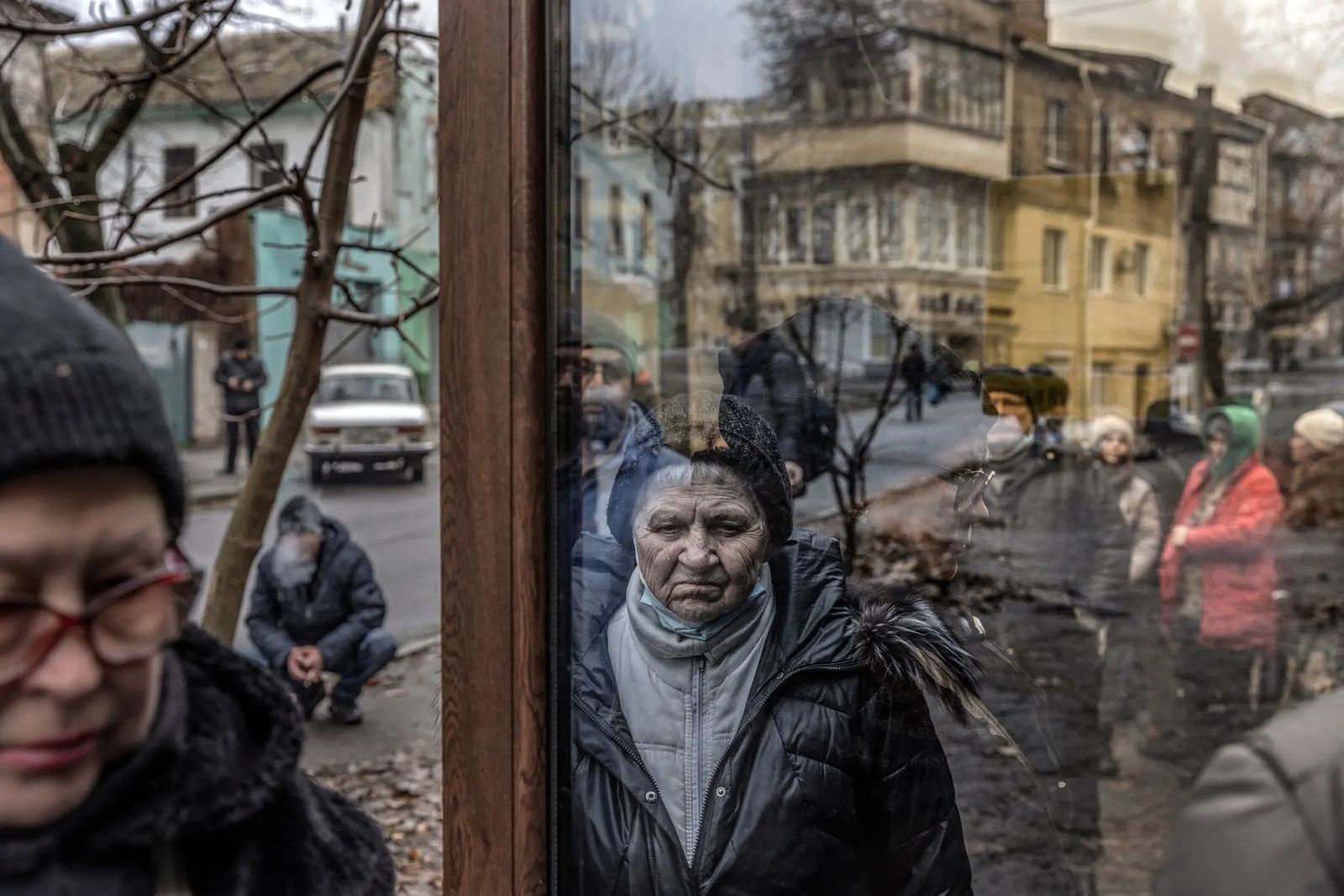 Жительница Херсона стоит в очереди возле пункта раздачи еды, организованном в подвальном помещении тату-салона. 8 декабря / David Guttenfelder / The New York Times 